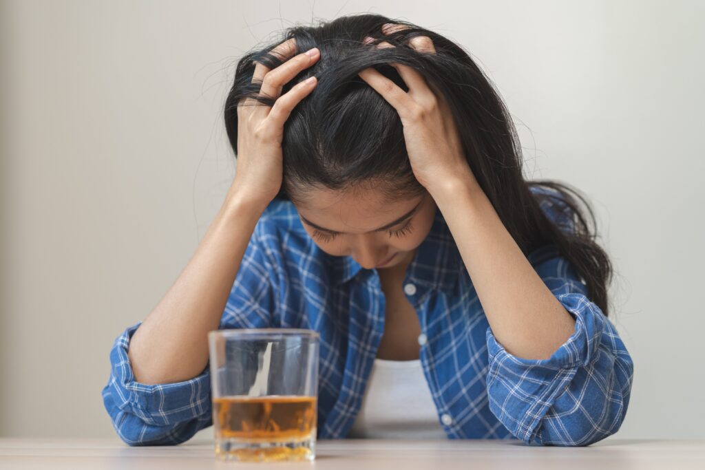 woman suffering from anxiety drinking alcohol