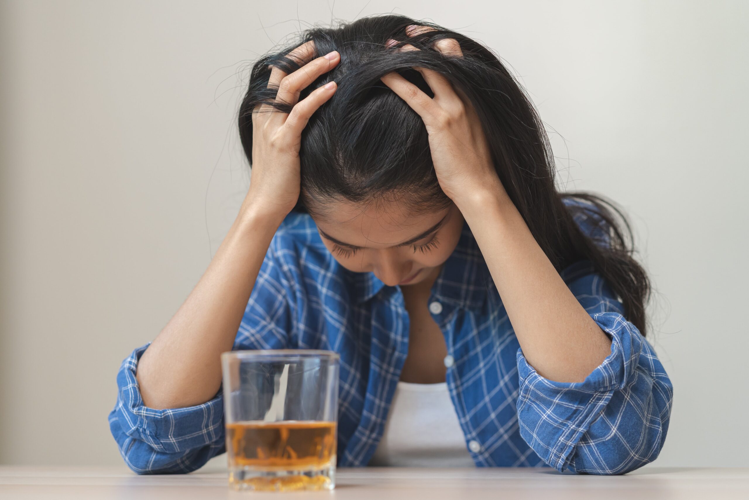 woman suffering from anxiety drinking alcohol