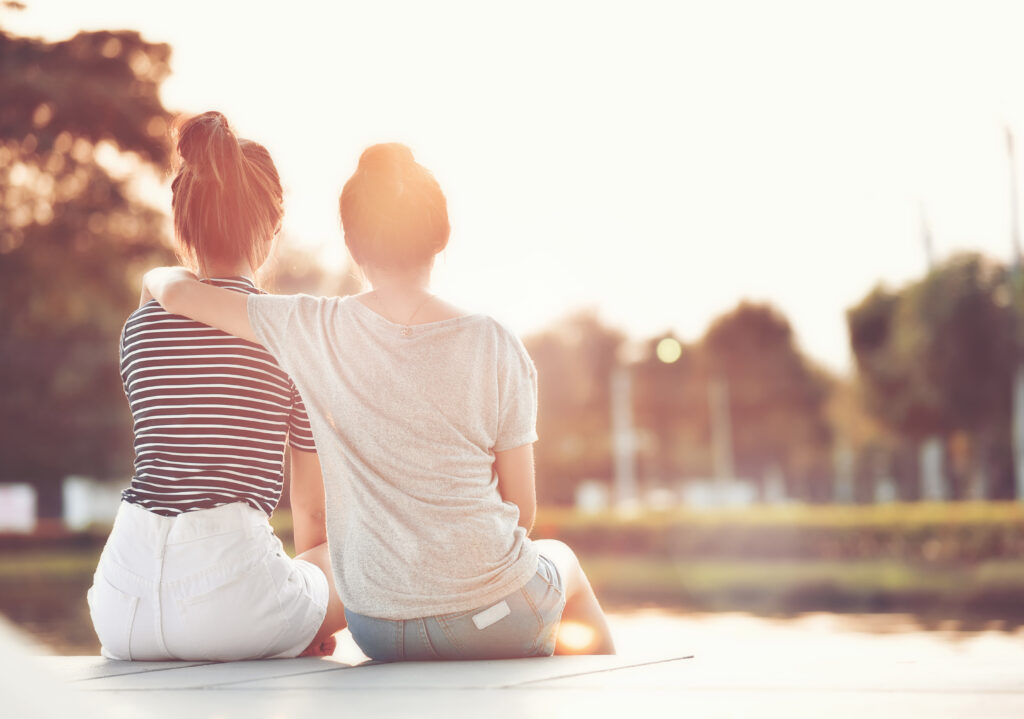 two women sitting outside