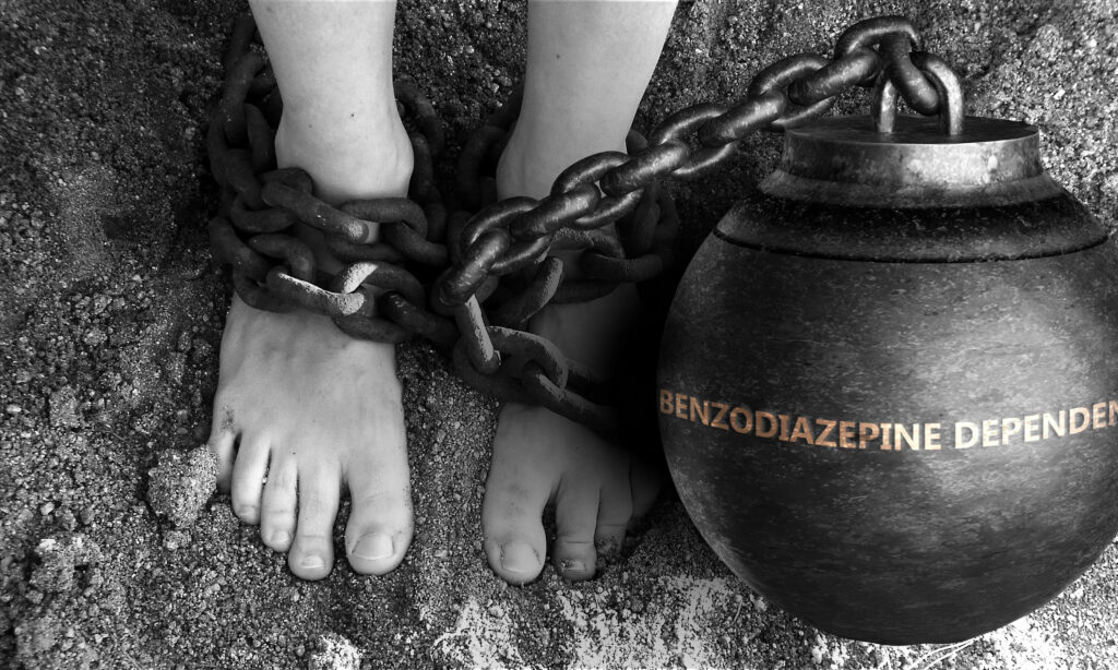 woman tied to a rock that says benzo addiction